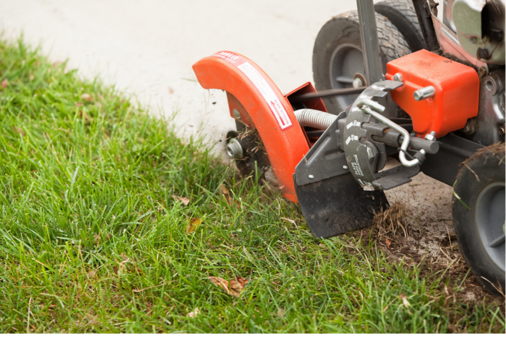 Professional lawn edging service creating clean landscape borders along a residential lawn in Connecticut