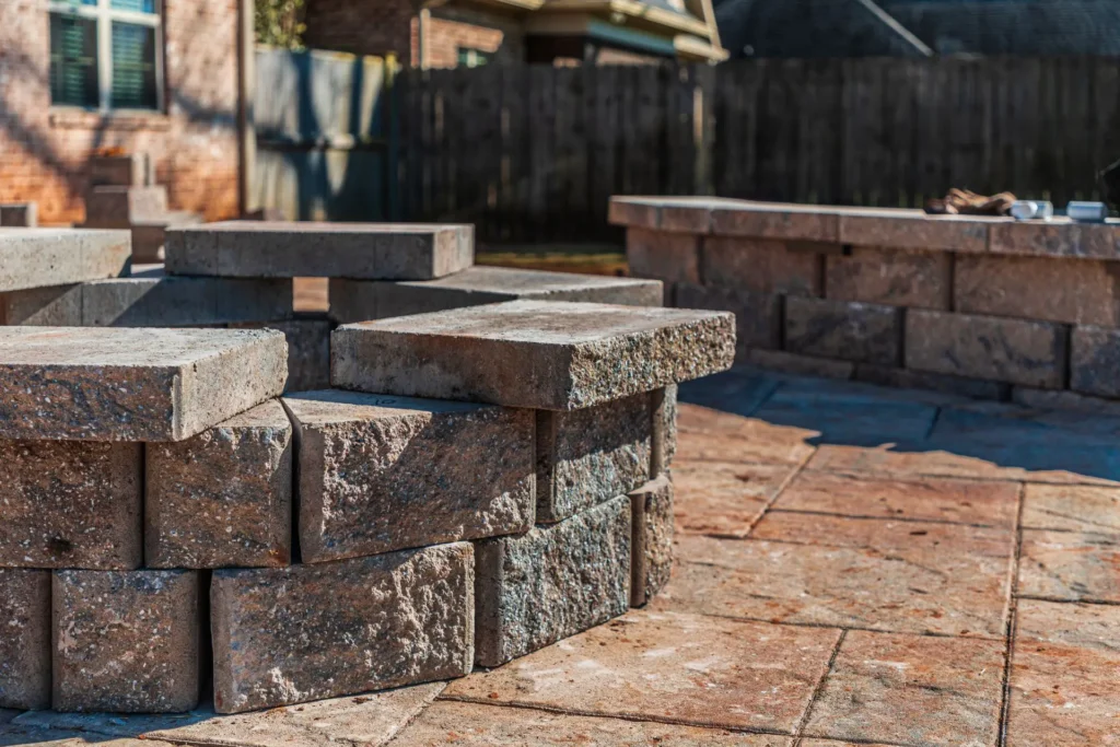 Custom paver fire pit and seating wall built with durable hardscaping materials for a Connecticut backyard